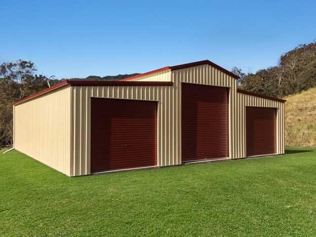 Cream barn-style shed with red roller doors