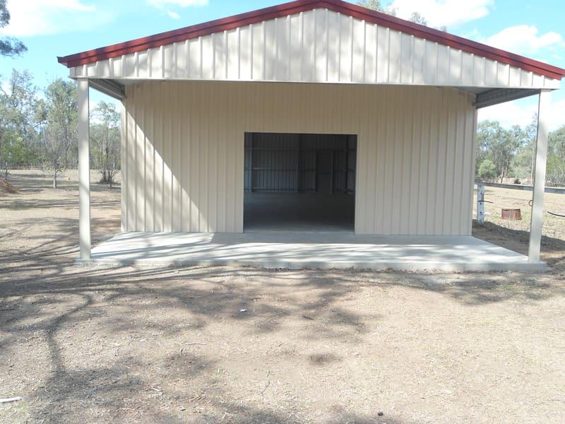 Cream gable shed with red trim and an open-front gable awning