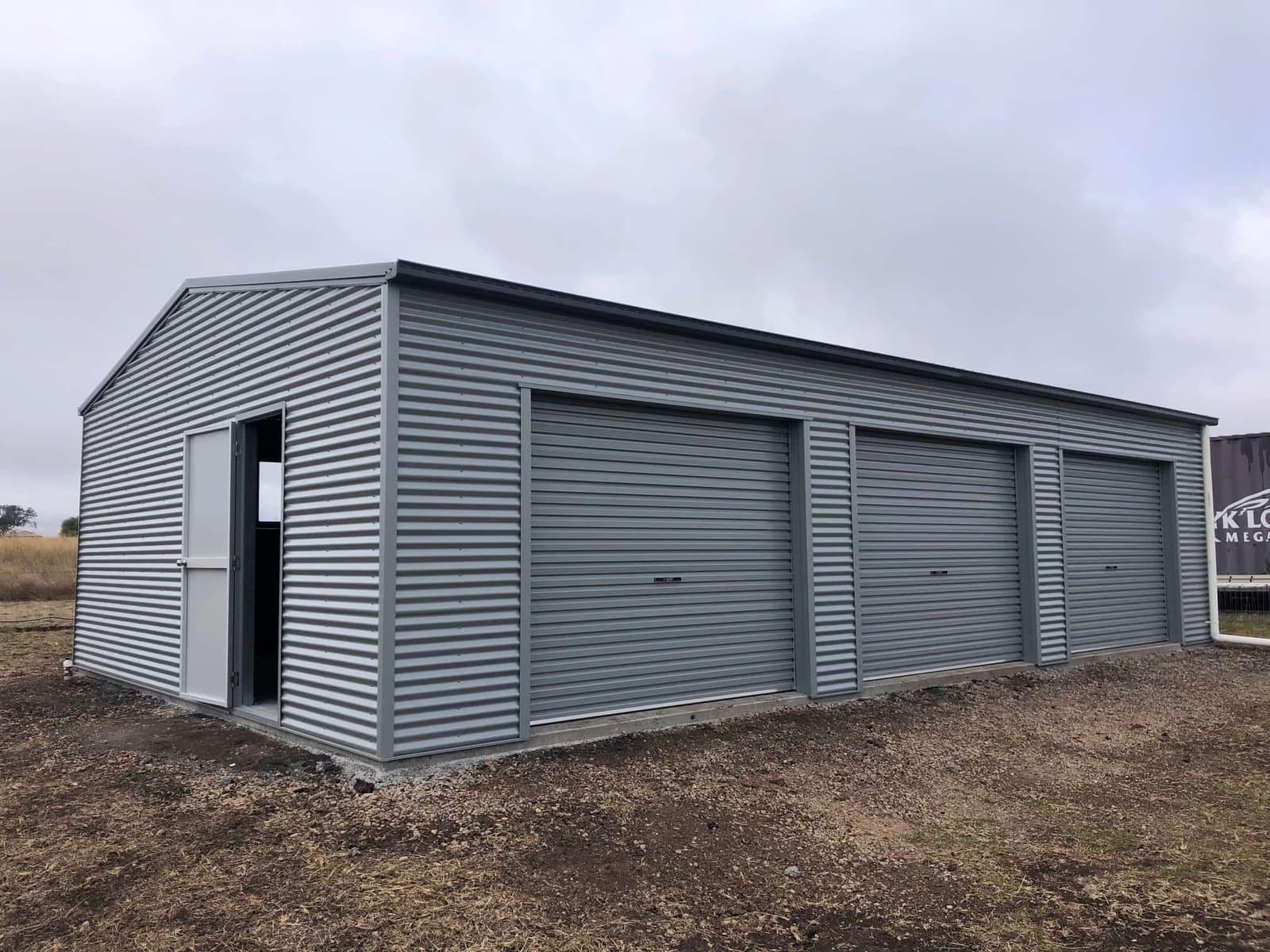 Grey three-bay steel garage